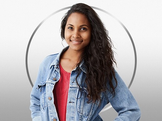 Smiling young woman with dark hair wearing red shirt and denim jacket, happy after Canesten ringworm treatment